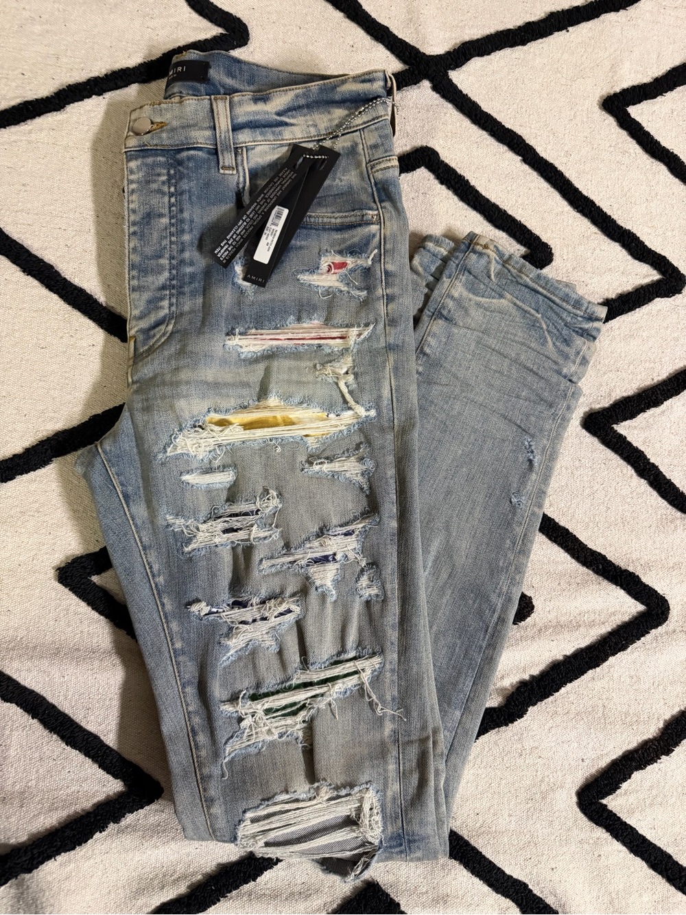 AMIRI Light Blue Distressed Skinny Jeans with Multicolor Patch Details